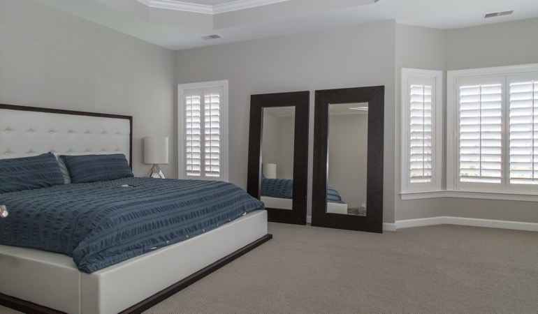White shutters in a minimalist bedroom in Sacramento.